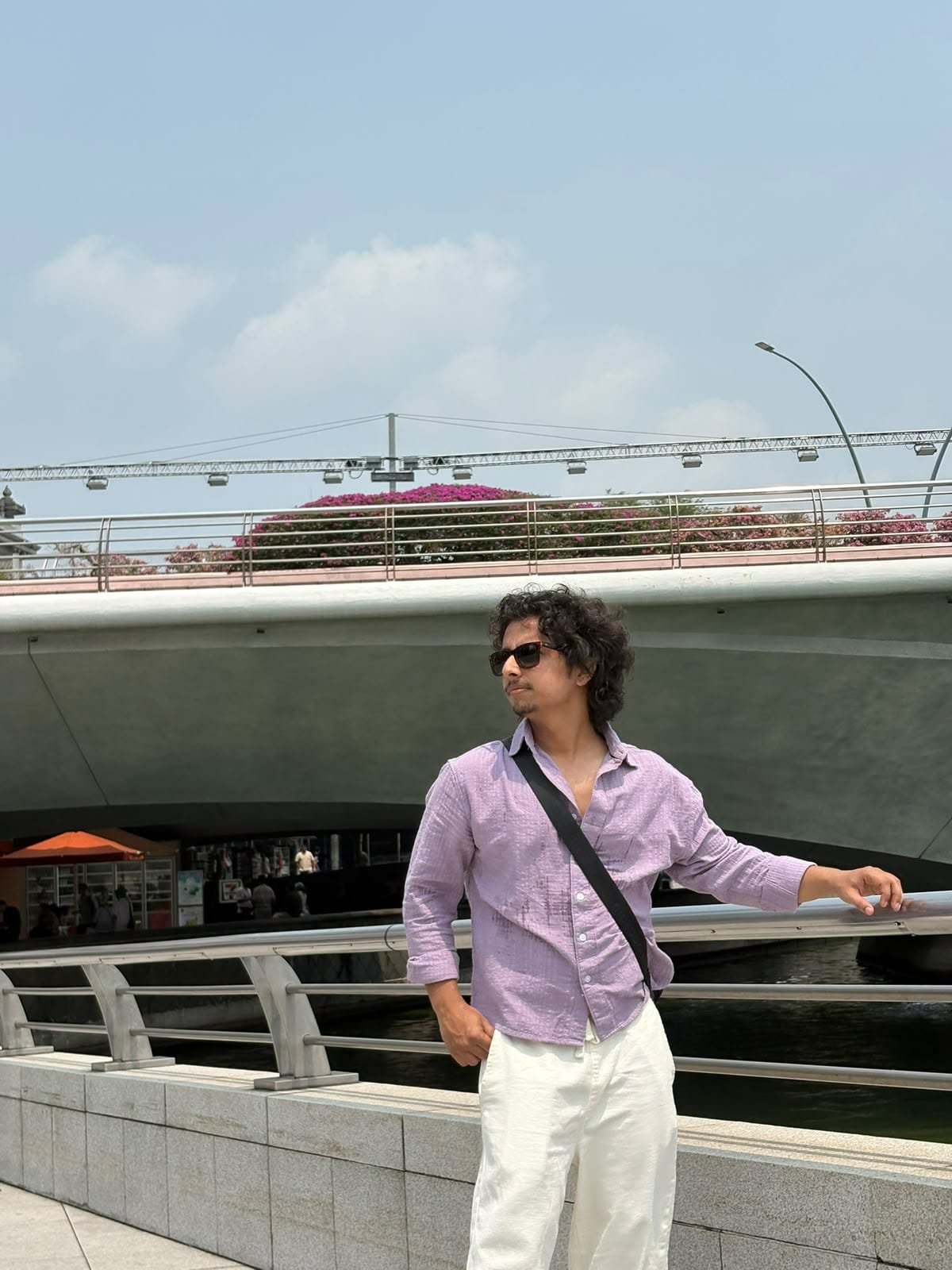 Rudra Singh standing by the river in Singapore